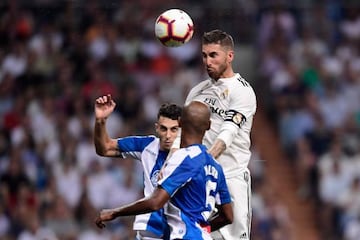 Sergio Ramos challenges Naldo and Mario Hermoso for the ball.