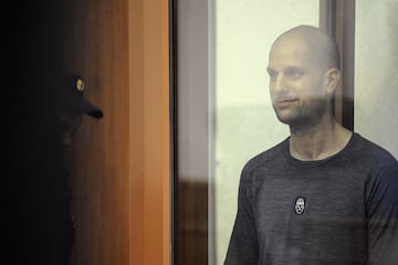 Wall Street Journal reporter Evan Gershkovich, who faces charges of espionage, stands inside an enclosure for defendants as he attends a court hearing in Yekaterinburg, Russia July 19, 2024. REUTERS/Dmitry Chasovitin