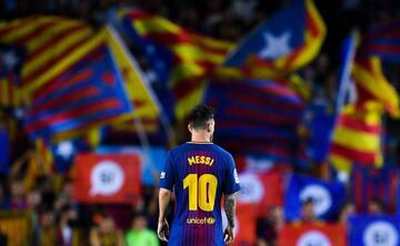 Lionel Messi of FC Barcelona looks on as Catalan Pro-Independence flags are seen on the background during the La Liga match between Barcelona and SD Eibar at Camp Nou on September 19, 2017 in Barcelona