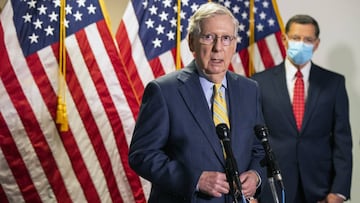 FILE - In this June 30, 2020, file photo, Senate Majority Leader Mitch McConnell, R-Ky., with Sen. John Barrasso, R-Wyo., speaks to reporters following a GOP policy meeting on Capitol Hill in Washington. President Donald Trump’s push to reopen schoo