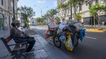 A paper recycler rests at a bench near San Martin Square, one of the main touristic sites in downtown Lima, which remains closed on April 9, 2020 during the lockdown to slow the spread of the coronavirus COVID-19 pandemic. - Mandatory social distancing du