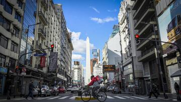 BUENOS AIRES, ARGENTINA - JULY 24: A delivery man crosses the Corrientes avenue known for its traitional pizza places on July 24, 2020 in Buenos Aires, Argentina. Traditional pizza restaurants of the iconic Corrientes Avenue in the Theater District struggle to survive during the government-ordered lockdown to curb spread of COVID-19. Since March 20, they can only work with delivery and take away, which in most cases represents a significant drop in their sales. Unable to adapt or be profitable, some pizzerias opted to remain closed until situation comes back to normal while others had to close down definitively. (Photo by Marcelo Endelli/Getty Images)