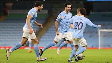 MANCHESTER, ENGLAND - JANUARY 17: Ilkay Gundogan of Manchester City celebrates with team mates (L - R) Ruben Dias and Bernardo Silva after scoring their side's second goal during the Premier League match between Manchester City and Crystal Palace at