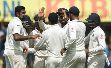 Ashwin (left) celebrates with his team-mates after taking the wicket of New Zealand's Ross Taylor during the third day of third Test in Indore.