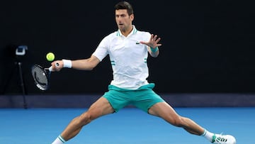 (FILES) In this file photo taken on February 21, 2021, Serbia's Novak Djokovic hits a return against Russia's Daniil Medvedev during their men's singles final match on day fourteen of the Australian Open tennis tournament in Melbourne. - De