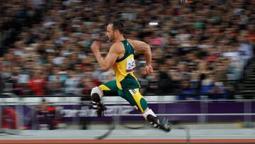 (FILES) South Africa's Oscar Pistorius competes in the men's 200m T44 round 1 athletics event during the London 2012 Paralympic Games at the Olympic Stadium in east London, on September 1, 2012. South African Paralympic champion Oscar Pistorius was granted early release from prison on parole on Friday, a decade after he killed his girlfriend, in a crime that gripped the world, prison authorities said. (Photo by IAN KINGTON / AFP)