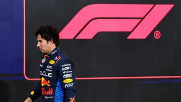 (FILES) Red Bull Racing's Mexican driver Sergio Perez walks to his garage after the qualifying session ahead of the Abu Dhabi Formula One Grand Prix at the Yas Marina Circuit in Abu Dhabi on December 7, 2024. Red Bull announced on December 18, 2024 that Mexican driver Sergio Perez has departed the Formula One team. Perez, 34, joined Red Bull in 2021 and helped the team earn two constructors' titles and completed a drivers' standing one-two with four-time world champion team-mate Max Verstappen in 2023. (Photo by HAMAD I MOHAMMED / POOL / AFP)