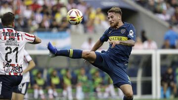 Boca Juniors&#039; Alexis MacAllister, right, leaps to kick the ball in front of Chivas&#039; Hiram Mier during the first half of a Colossus Cup soccer match Saturday, July 6, 2019, in Seattle. (AP Photo/Elaine Thompson)