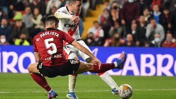 MADRID, SPAIN - APRIL 11: Sergi Guardiola of Rayo Vallecano shoots past Gabirel Paulista of Valencia CF to score their team&#039;s first goal during the La Liga Santander match between Rayo Vallecano and Valencia CF at Campo de Futbol de Vallecas on April