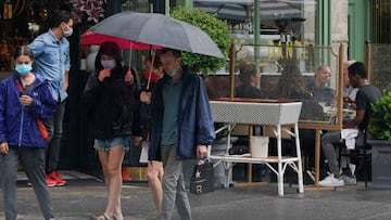 People eat brunch outside of a restaurant in the West Village on August 16, 2020 in New York. Five months after New York City shut down to combat the coronavirus, the tourism industry remains flat. 