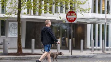 A pedestrian walks his dog near the closed World Bank Group headquarters in Washington, DC. 