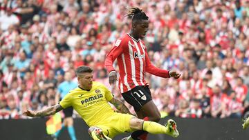 Villarreal's Spanish defender #18 Alberto Moreno falls as he vies with Athletic Bilbao's Spanish forward #11 Nico Williams during the Spanish league football match between Athletic Club Bilbao and Villarreal CF at the San Mames stadium in Bilbao on April 14, 2024. (Photo by ANDER GILLENEA / AFP)