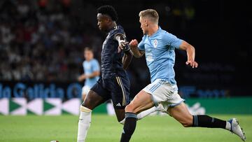 Real Madrid's Brazilian forward #07 Vinicius Junior (L) vies with Celta Vigo's Swedish defender #02 Carl Starfelt during the Spanish Liga football match between RC Celta de Vigo and Real Madrid CF at the Balaidos stadium in Vigo on August 25, 2023. (Photo by MIGUEL RIOPA / AFP)