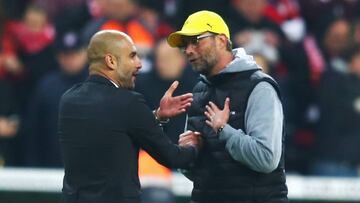Head coaches Pep Guardiola of Muenchen and Juergen Klopp of Dortmund discuss during the DFB Cup Semi Final match between FC Bayern Muenchen and Borussia Dortmund at Allianz Arena