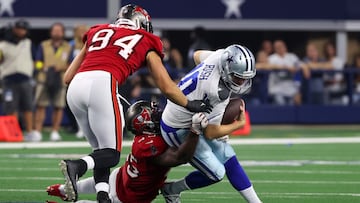 ARLINGTON, TEXAS - SEPTEMBER 11: Devin White #45 of the Tampa Bay Buccaneers tackles Cooper Rush #10 of the Dallas Cowboys during the second half at AT&T Stadium on September 11, 2022 in Arlington, Texas.   Richard Rodriguez/Getty Images/AFP