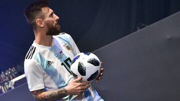Barcelona and Argentina forward Lionel Messi poses with the official match ball for the 2018 World Cup football tournament, named "Telstar 18", during its unveiling ceremony in Moscow on November 9, 2017
