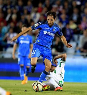 El centrocampista del Getafe, Miguel Ángel Herrero "Michel", se lleva el balón ante el defensor del Córdoba.