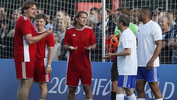 Team members, including chairman of the Local Organising Committee for the soccer World Cup Arkady Dvorkovich (2nd R) and former professional players Michel Salgado (3rd L), Julio Baptista (R) and Dmitry Bulykin (L), speak during an exhibition match, part