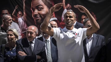 French basketball player Tony Parker (R) and French Interior Minister Gerard Collomb (L) attend the the laying of the first stone of Tony Parker Adequat Academy on June 29, 2018, in Lyon. / AFP PHOTO / JEAN-PHILIPPE KSIAZEK