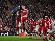 Liverpool's Brazilian goalkeeper #01 Alisson (L) makes a save next to Liverpool's French forward #22 Hugo Ekitike (C) during the UEFA Champions League, round of 16 second leg football match between Liverpool and Galatasaray at Anfield in Liverpool, north-west England on March 18, 2026. (Photo by Paul ELLIS / AFP)