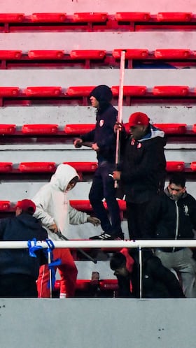 Independiente supporters attack a Universidad de Chile fan during the second leg of the Copa Sudamericana Round of 16 match, which was suspended due to violence in the stands, with the Chilean side leading on aggregate, in Avellaneda, Argentina August 20, 2025. REUTERS/Facundo Morales
