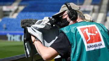 Soccer Football - Bundesliga - TSG 1899 Hoffenheim v Hertha BSC - PreZero Arena, Sinsheim, Germany - May 16, 2020 A TV camera operator wears a protective face mask before the match, as play resumes behind closed doors following the outbreak of the coronav