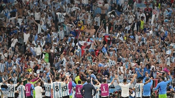 Argentina players go over to celebrate in front of their fans after the Qatar 2022 World Cup Group C football match between Argentina and Mexico at the Lusail Stadium in Lusail, north of Doha on November 26, 2022. (Photo by Glyn KIRK / AFP)