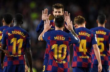 Barcelona's Argentine forward Lionel Messi celebrates his goal with Barcelona's Spanish defender Gerard Pique during the Spanish league football match between FC Barcelona and Sevilla FC at the Camp Nou stadium in Barcelona on October 6, 2019