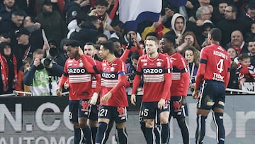 Lille's Canadian forward Jonathan David (L) celebrates with teammates after scoring his first goal during the French L1 football match between Lille LOSC and Olympique Lyonnais (OL) at Stade Pierre-Mauroy in Villeneuve-d'Ascq, northern France, on March 10, 2023. (Photo by Sameer Al-DOUMY / AFP)