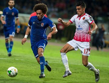 Wydad Casablanca's Achraf Bencharki (R) vies for the ball against Al-Ahly's Hussein Sayed during the CAF Champions League final football match between Egypt's Al-Ahly and Morocco's Wydad Casablanca on November 4, 2017, at Mohamed V Stadium in Casablanca. 