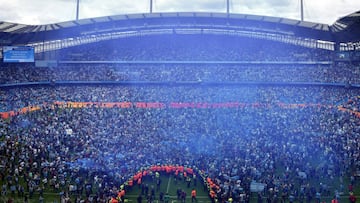 MANCHESTER, ENGLAND - MAY 22: Manchester City fans celebrate on the pitch after their side finished the season as Premier League champions during the Premier League match between Manchester City and Aston Villa at Etihad Stadium on May 22, 2022 in Manchester, England. (Photo by Manchester City FC/Manchester City FC via Getty Images)