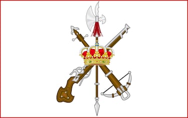 Formado por la pica, la ballesta y el arcabuz, simboliza la continuidad histórica del combatiente español. Representa la unión entre tradición militar, espíritu ofensivo y entrega absoluta al servicio.