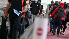Passengers head to a Covid-19 quarantine station for clearance following their arrival at Tokyo&#039;s Haneda Airport 