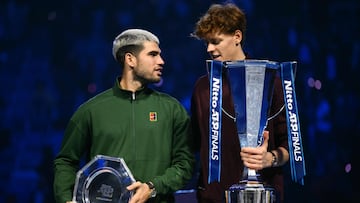 Spain's Carlos Alcaraz (L) and Italy's Jannik Sinner speak during the trophy ceremony at the end of their men's single final match at the ATP Finals tennis tournament, in Turin, on November 16, 2025. (Photo by Marco BERTORELLO / AFP)