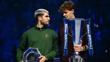 Spain's Carlos Alcaraz (L) and Italy's Jannik Sinner speak during the trophy ceremony at the end of their men's single final match at the ATP Finals tennis tournament, in Turin, on November 16, 2025. (Photo by Marco BERTORELLO / AFP)