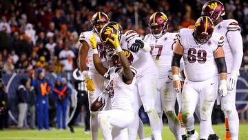 CHICAGO, ILLINOIS - OCTOBER 13: Brian Robinson #8 of the Washington Commanders celebrates his touchdown during the fourth quarter against the Chicago Bears at Soldier Field on October 13, 2022 in Chicago, Illinois. Michael Reaves/Getty Images/AFP