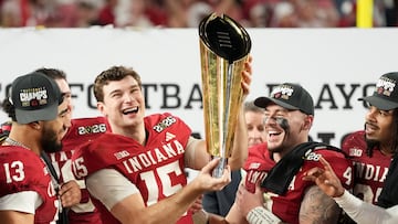 Jan 19, 2026; Miami Gardens, FL, USA; Indiana Hoosiers quarterback Fernando Mendoza (15) lifts the trophy after the College Football Playoff National Championship game against the Miami Hurricanes at Hard Rock Stadium. Mandatory Credit: Kirby Lee-Imagn Images