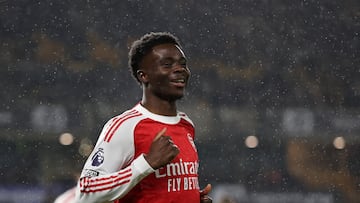 Soccer Football - Premier League - Wolverhampton Wanderers v Arsenal - Molineux Stadium, Wolverhampton, Britain - February 18, 2026 Arsenal's Bukayo Saka celebrates scoring their first goal REUTERS/Chris Radburn EDITORIAL USE ONLY. NO USE WITH UNAUTHORIZED AUDIO, VIDEO, DATA, FIXTURE LISTS, CLUB/LEAGUE LOGOS OR 'LIVE' SERVICES. ONLINE IN-MATCH USE LIMITED TO 120 IMAGES, NO VIDEO EMULATION. NO USE IN BETTING, GAMES OR SINGLE CLUB/LEAGUE/PLAYER PUBLICATIONS. PLEASE CONTACT YOUR ACCOUNT REPRESENTATIVE FOR FURTHER DETAILS..