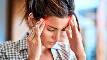 Shot of a uncomfortable looking woman holding her head in discomfort due to pain at home during the day