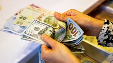 A money changer counts U.S. dollar banknotes at a currency exchange office in Ankara, Turkey September 27, 2021.