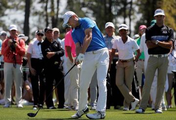 Masters champion Jordan Spieth is watched by Bubba Watson, Gary Player and Condoleezza Rice as starts a practice round on the first tee at Augusta National.