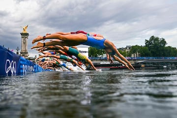Athletes compete in the swimming race in the Seine during the women's individual triathlon.