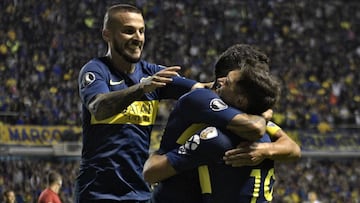 Argentina's Boca Juniors forward Mauro Zarate (R) celebrates with teammates forward Carlos Tevez (C) and forward Dario Benedetto after scoring the team's third goal against Colombia's Deportes Tolima during a Copa Libertadores 2019 group G football match at the "Bombonera" stadium in Buenos Aires, Argentina, on March 12, 2019. (Photo by JUAN MABROMATA / AFP)