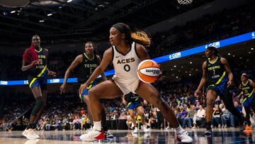 Sep 29, 2023; Arlington, Texas, USA; Las Vegas Aces guard Jackie Young (0) controls the ball as Dallas Wings center Kalani Brown (21) and forward Natasha Howard (6) look on during the second half during game three of the 2023 WNBA Playoffs at College Park Center. Mandatory Credit: Jerome Miron-USA TODAY Sports