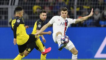 FILE - In this Tuesday, Feb. 18, 2020 file photo, Dortmund&#039;s Jadon Sancho, left, and PSG&#039;s Thomas Meunier duels for the ball during the Champions League round of 16 first leg soccer match between Borussia Dortmund and Paris Saint Germain in Dort