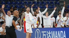 Spain's Juancho Hernangomez and teammates celebrate on the bench.