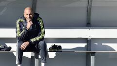 Real Madrid&#039;s new French coach Zinedine Zidane looks on as he sits on a bench during his first training session as coach of Real Madrid at the Alfredo di Stefano Stadium in Valdebebas, on the outskirts of Madrid, on January 5, 2016. Real Madrid legend Zinedine Zidane promised to put his &quot;heart and soul&quot; into managing the Spanish giants after he was sensationally named as coach following Rafael Benitez&#039;s unceremonious sacking.   AFP PHOTO/ GERARD JULIEN / AFP / GERARD JULIEN        (Photo credit should read GERARD JULIEN/AFP/Getty Images)