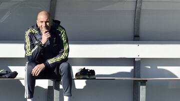 Real Madrid's new French coach Zinedine Zidane looks on as he sits on a bench during his first training session as coach of Real Madrid at the Alfredo di Stefano Stadium in Valdebebas, on the outskirts of Madrid, on January 5, 2016. Real Madrid legend Zinedine Zidane promised to put his "heart and soul" into managing the Spanish giants after he was sensationally named as coach following Rafael Benitez's unceremonious sacking. AFP PHOTO/ GERARD JULIEN / AFP / GERARD JULIEN (Photo credit should read GERARD JULIEN/AFP/Getty Images)