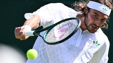 Greece's Stefanos Tsitsipas plays a backhand return to France's Valentin Royer during their men's singles first round tennis match on the first day of the 2025 Wimbledon Championships at The All England Lawn Tennis and Croquet Club in Wimbledon, southwest London, on June 30, 2025. (Photo by Kirill KUDRYAVTSEV / AFP) / RESTRICTED TO EDITORIAL USE