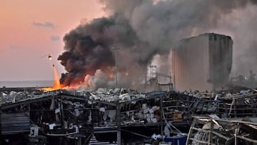 A helicopter puts out a fire at the scene of an explosion at the port of Lebanon&#039;s capital Beirut on August 4, 2020.